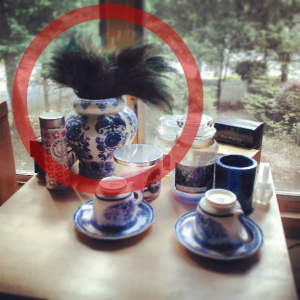 The Pavorio pigno, a blue and white vase filled with peacock feathers representing the goddess Hera or Juno.